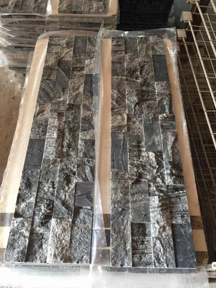 Real product photo — complete mesh-mounted sheet of the dark split-face stacked natural marble mosaic; natural stone variation and approved sample control final appearance
