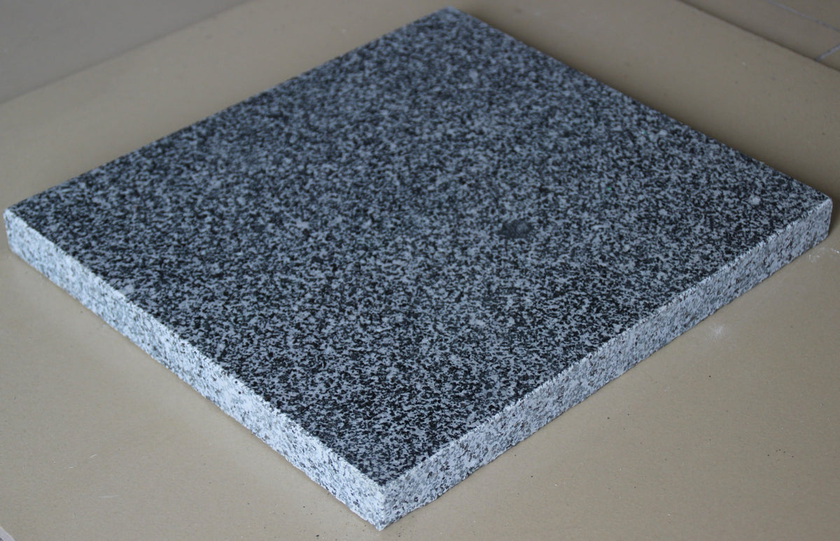 Real product photo — Laizhou Green natural granite slab showing the polished surface and cut edge; approved sample controls final mineral pattern and finish